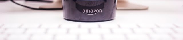 Amazon logo on the Echo dot over a keyboard